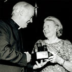 Margie Grace accepts the Flax Trust Award on behalf of her husband Peter Grace, W R Grace from Fr Myles Kavanagh CP